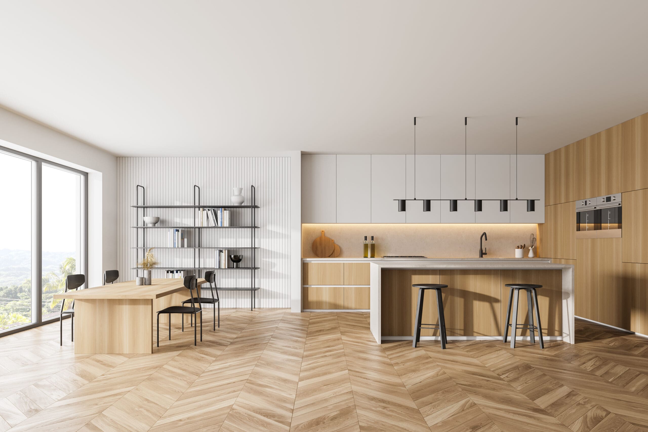 Modern kitchen interior with wood and white cabinetry, featuring an island with bar stools. A dining table with chairs is nearby. Shelves display decor. Large windows provide natural light, illuminating the herringbone wood floor.