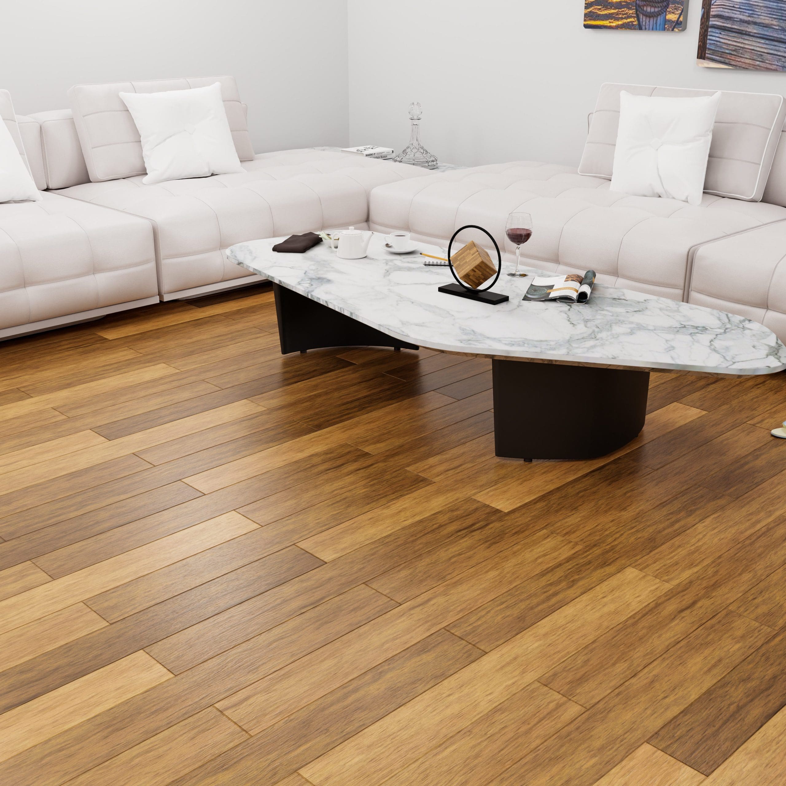 A modern living room features two white sofas facing each other near a marble coffee table on a polished wooden floor. The table holds a book, a wine glass, and a small round mirror. Neutral-toned pillows accentuate the sofas.